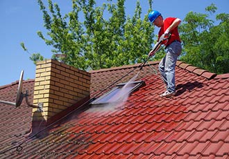 worker doing a roof cleaning