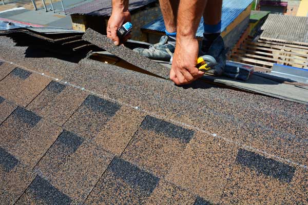 Roofer roofing a house.