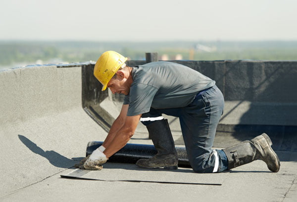 Roofer working on commercial roof.