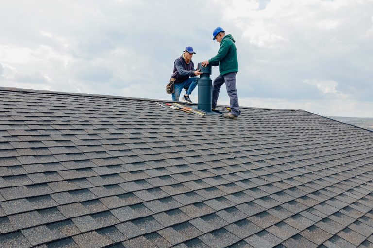 Workers performing roof maintenance